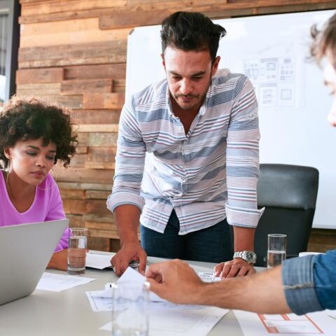 End-users and researchers discussing design prototypes together, as part of a generative user research method.