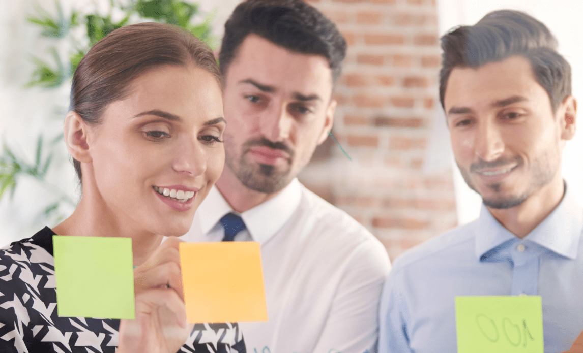 team looking at sticky notes