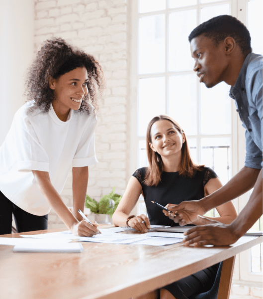 three coworkers standing around table