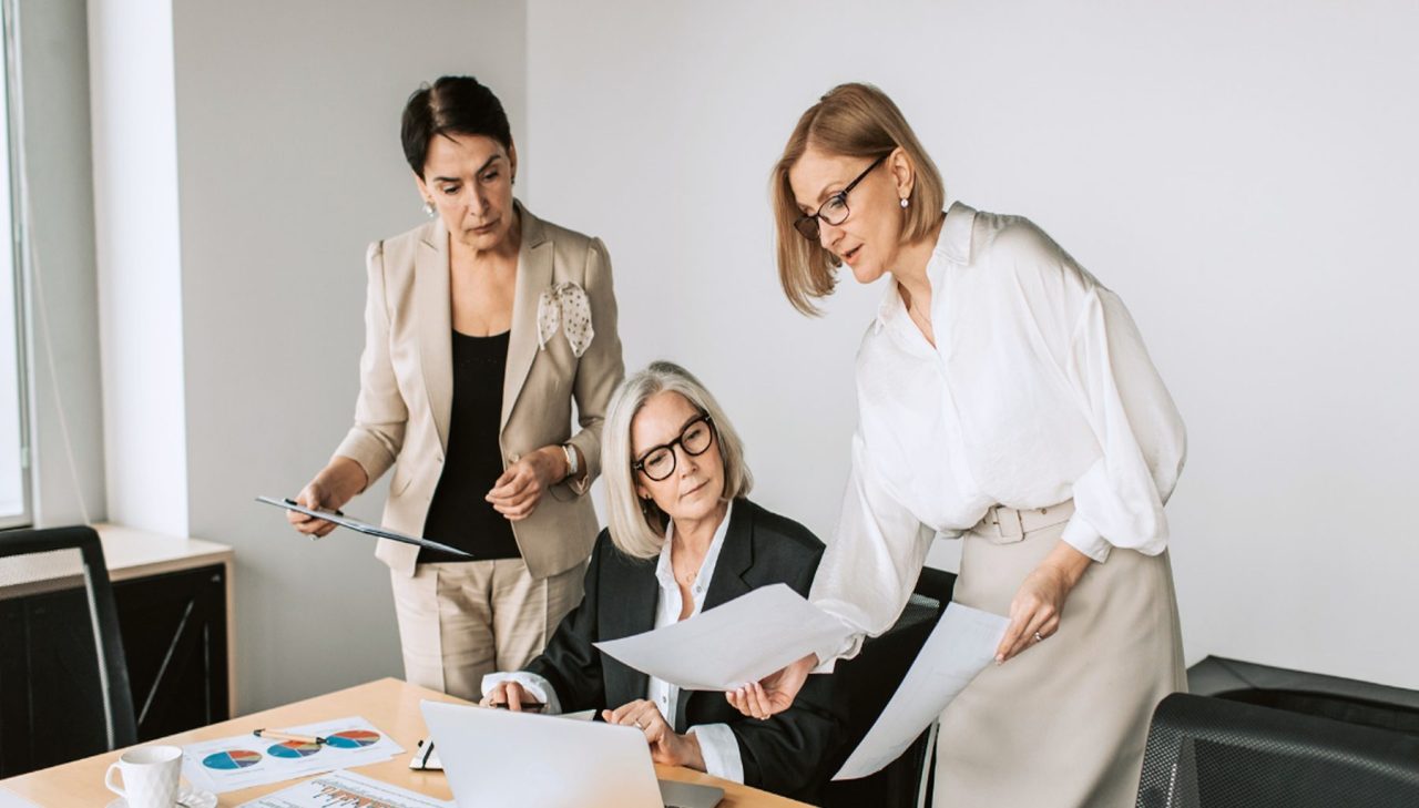 Image of teams reviewing how design research fits into their day to day work, for a design research training case study with a social impact agency.