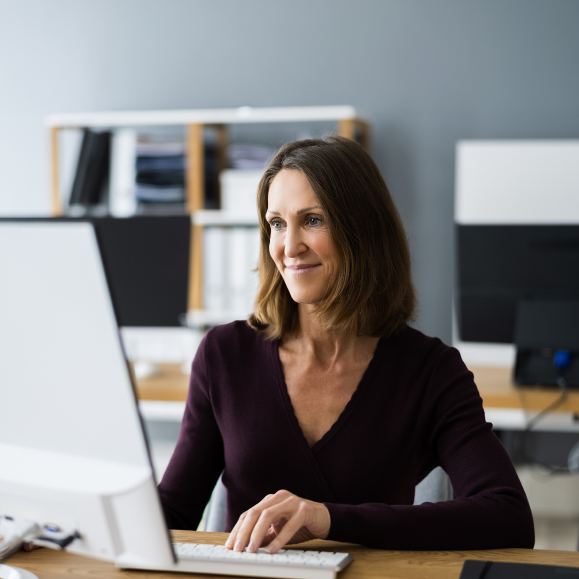 Professional taking the self-led version of the Design Research Mastery course on a desktop computer.
